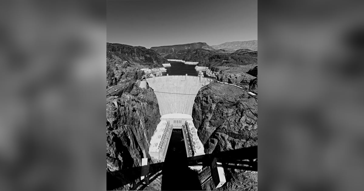 Hoover Dam holding back Lake Mead, with the reservoir's pale shoreline visible